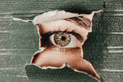 A green eye looking through the hole