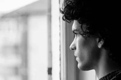 A man is looking from the window
