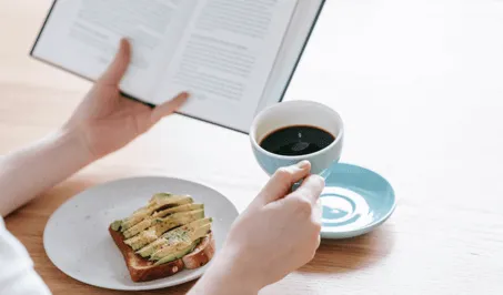 Person drinking coffee and reading